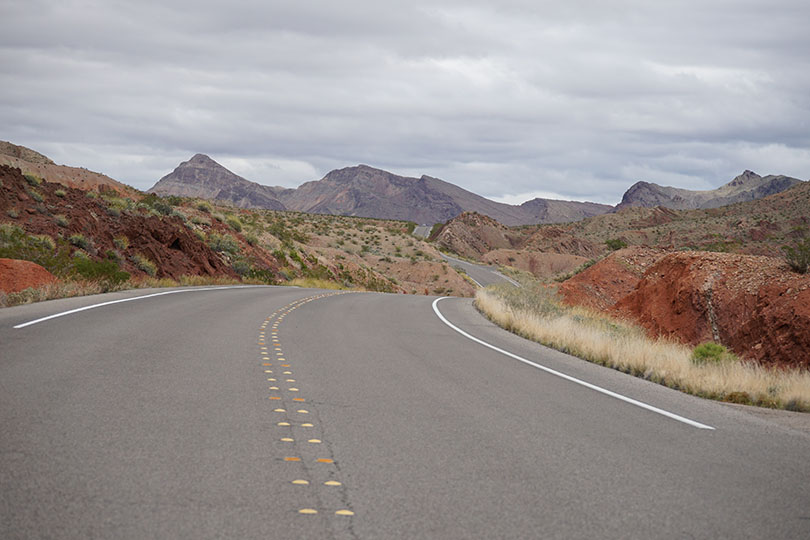 Road leading into Lake Mead National Recreation Area with mountains in the distance.